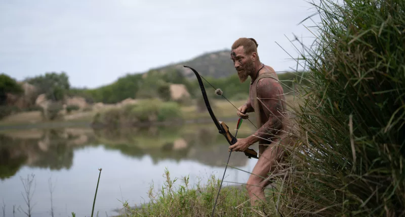 Man holding a bow and arrow on