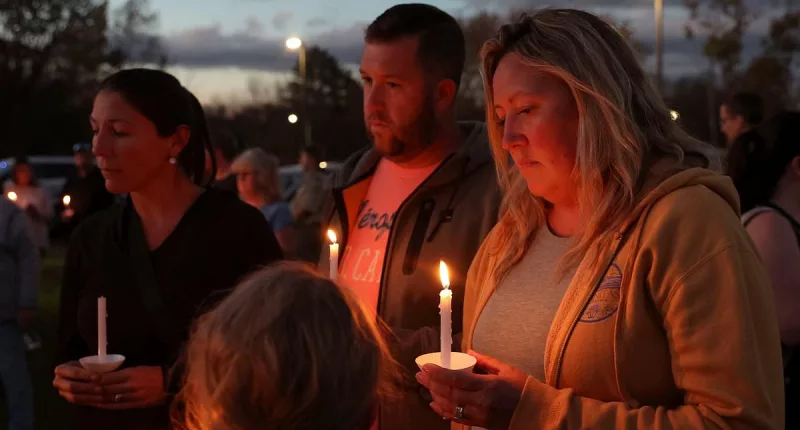 Hundreds mourn victims of Maine mass shooting at candlelit vigil