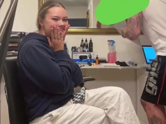 The excited customer waiting to be tatted, unaware that she was moments away from a tattoo nightmare