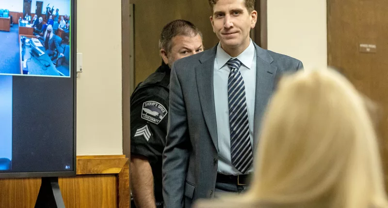 Bryan Kohberger smiles as he enters the courtroom for a hearing at the Latah County Courthouse in Moscow, Idaho