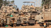 Israeli armoured vehicles gathered near the Gaza border, as the nation’s Shin Bet internal security service started hunting down Hamas monsters
