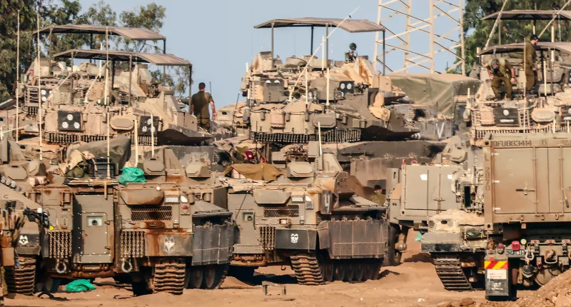 Israeli armoured vehicles gathered near the Gaza border, as the nation’s Shin Bet internal security service started hunting down Hamas monsters