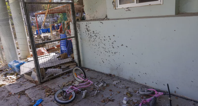 Children’s bikes littered by a bullet ridden wall at the horror scene