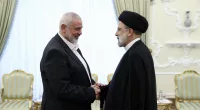 President Ebrahim Raisi, right, greets the leader of the Palestinian terrorist group Hamas, Ismail Haniyeh