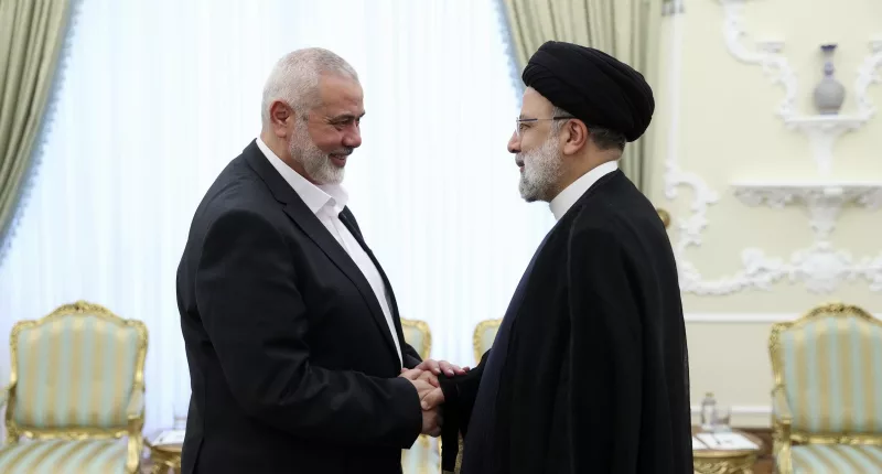 President Ebrahim Raisi, right, greets the leader of the Palestinian terrorist group Hamas, Ismail Haniyeh