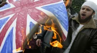 Members of the Islamic extremist group Al Muhajiroun burn a Union Jack flag outside the London Central Mosque in Regents Park