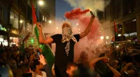 People take part in a ‘Stand with Palestine’ demonstration, close to the Embassy of Israel, in west London