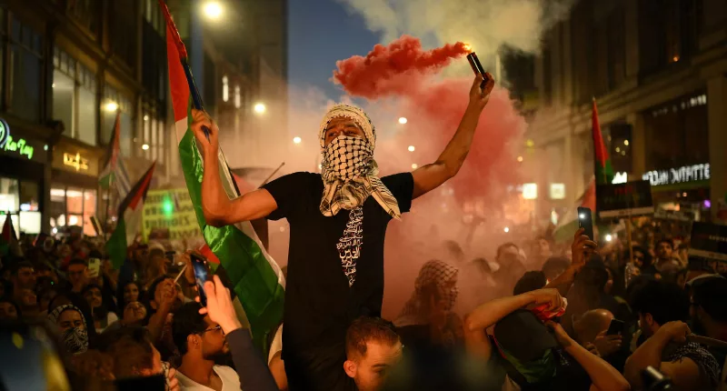 People take part in a ‘Stand with Palestine’ demonstration, close to the Embassy of Israel, in west London