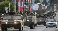 Israeli soldiers patrol in armoured personnel carriers in northern Israel near the border with Lebanon