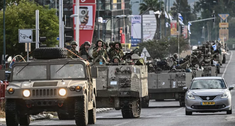 Israeli soldiers patrol in armoured personnel carriers in northern Israel near the border with Lebanon
