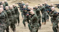 Hezbollah fighters demonstrate military maneuvers during a press tour in the southern Lebanese village of Aaramta