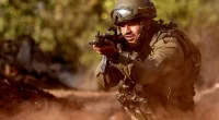 An Israeli army soldier advances during a drill in the country's north
