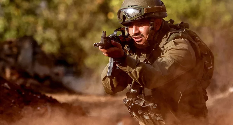 An Israeli army soldier advances during a drill in the country's north