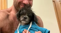 Lee was all smiles as he held up one of the pups he has recently rescued
