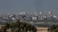 Smoke rises amid destroyed buildings in Gaza seen from Sderot