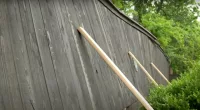 An unstable privacy fence surrounding a homeowner's yard in Oklahoma is supposedly near its collapsing point