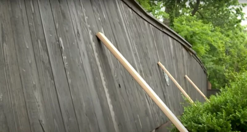 An unstable privacy fence surrounding a homeowner's yard in Oklahoma is supposedly near its collapsing point