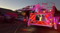 One person is dead and another is in serious condition after a plane crashed into the roof of a home