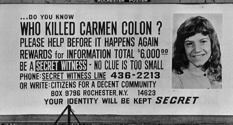 A billboard asking who killed Carmen Colon