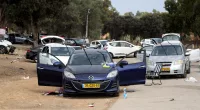 Abandoned cars and scattered belongings litter the road  after the deadly terror attack on Israel
