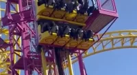 Rollercoaster riders were trapped dangling in the air for over half an hour