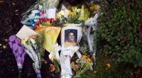 A photo of Jacob Wetterling and flowers in a memorial near jacobs home