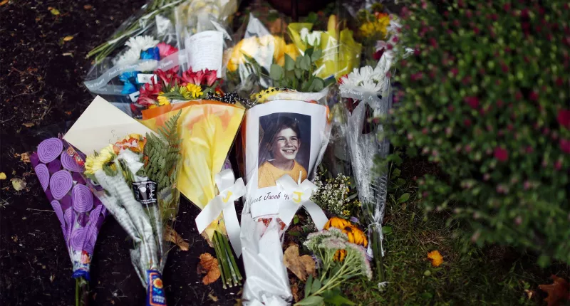A photo of Jacob Wetterling and flowers in a memorial near jacobs home