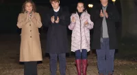 Colin, right, claps in tribute to his father-in-law Captain Sir Tom Moore with wife Hannah, left, son Benji and daughter Georgia