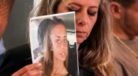 Mia Shem's mother holds up a picture of her daughter who is being held captive in the Gaza Strip