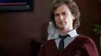 Matthew Gray Gubler as Spencer Reid, wearing a v-neck sweater, in