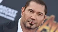 Dave Bautista posing in a suit at the premiere of