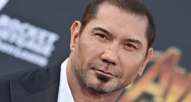 Dave Bautista posing in a suit at the premiere of