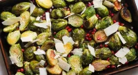 lemon pomegranate brussels sprouts on a sheet pan