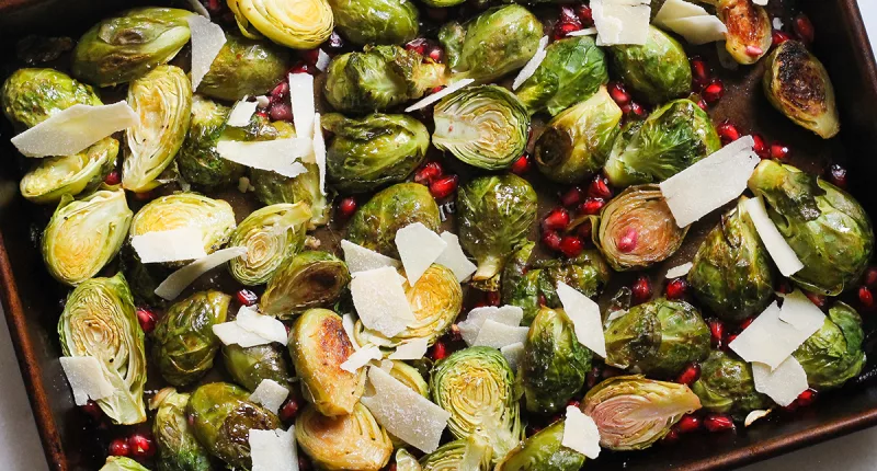 lemon pomegranate brussels sprouts on a sheet pan