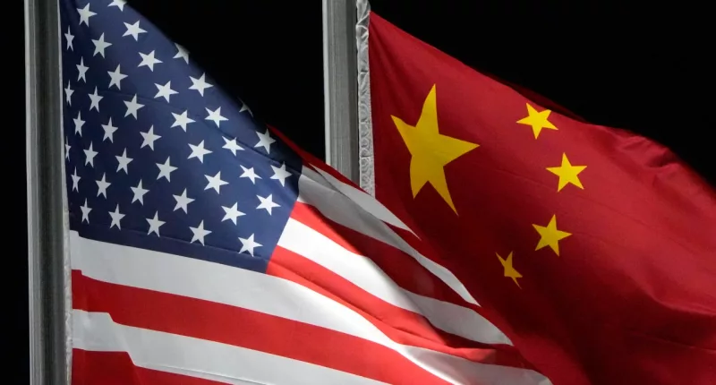 FILE - The American and Chinese flags wave at Genting Snow Park ahead of the 2022 Winter Olympics, Feb. 2, 2022, in Zhangjiakou, China. President Joe Biden and Chinese President Xi Jinping will hold a long-anticipated meeting Wednesday in the San Francisco Bay area. That