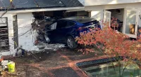 California Tesla driver flies over pool, crashes through house and stops in kitchen, police say