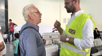 A Brit official speaks to a recent arrival at Rafah crossing on the border of Gaza and Egypt as dozens of UK citizens make it out of the Strip