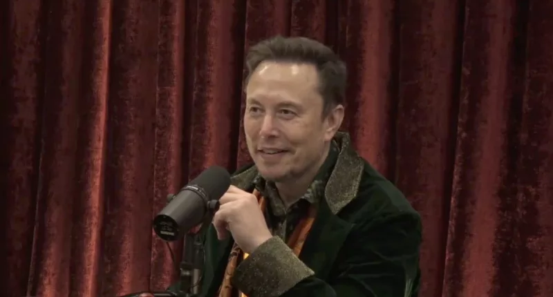 Musk donned an orange scarf and emerald green jacket