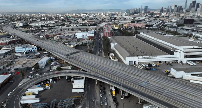 In this aerial view, traffic is backed up under a closed Interstate 10 in the aftermath of a fire, Monday, Nov. 13, 2023, in Los Angeles. Los Angeles drivers are being tested in their first commute since a weekend fire that closed a major elevated interstate near downtown. (AP Photo/Jae C. Hong)