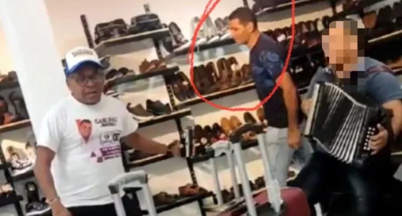 A chilling picture put out by Colombian media shows one of the kidnappers standing behind Diaz in a shoe shop as he kept an eye on the unaware father