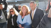(Pictured center in blue) Asa Ellerup, the estranged wife of the accused Long Island Serial Killer, Rex Heuermann, showed up to a court hearing in Long Island, New York on Wednesday