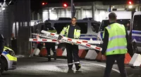 Parts of a destroyed barrier are removed form a gate at the airport in Hamburg