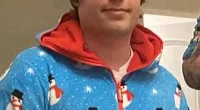 But there he was in a Thanksgiving Instagram post appeared to be very much a part of the family as he wore a Christmas onesie