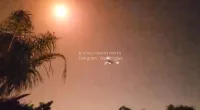 The plane can be seen dangerously close to a bright explosion in the sky above it, thought to have been caused by Israel's Iron Dome defence system