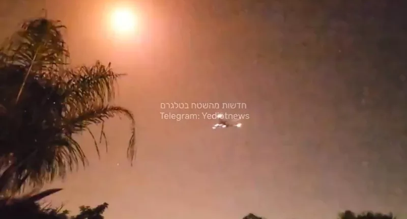 The plane can be seen dangerously close to a bright explosion in the sky above it, thought to have been caused by Israel's Iron Dome defence system