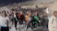 Huge stampede of migrants crosses into US through Tijuana River
