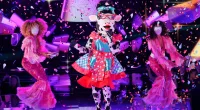 Cow performing on stage with backup dancers in