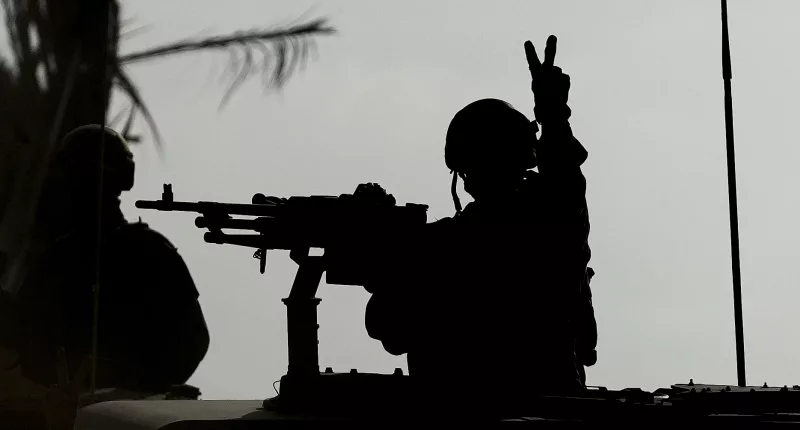 An Israeli soldier flashes a V for Victory sign as their tanks rolled into Gaza City to wipe out Hamas