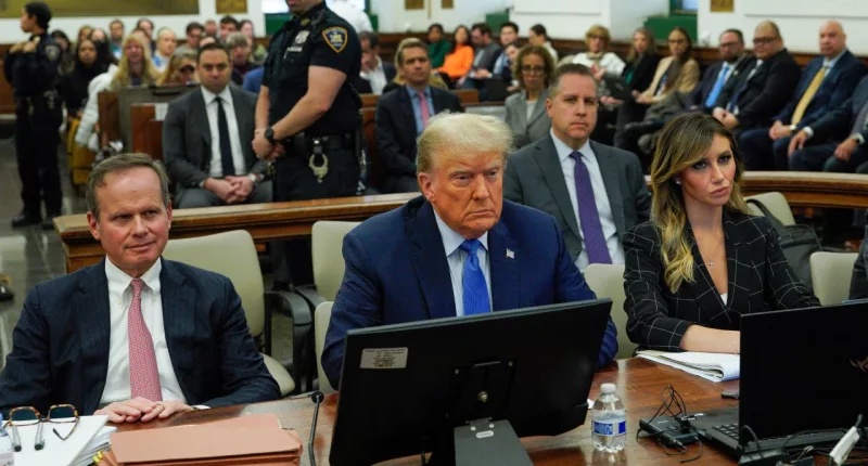 Flanked by his attorneys Chris Kise, left, and Alina Habba, former President Donald Trump waits to take the witness stand at New York Supreme Court, Monday, Nov. 6, 2023, in New York. (AP Photo/Eduardo Munoz Alvarez)
