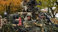 Kate dons camouflage gear to drive a vehicle around Norfolk barracks